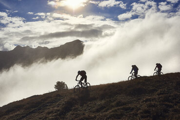 Three people mountain biking, Valais, Switzerland - CUF23886