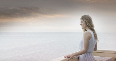 Young woman gazing out to sea from balcony, Miami Beach, Florida, USA - CUF24059