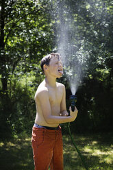 Boy playing with garden hose - CUF24124