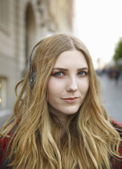 Portrait of blond young woman with headphones - CUF24131