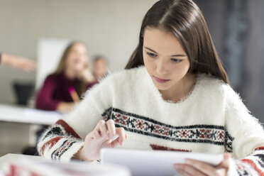 Teenage girl using tablet in class - ZEF15662
