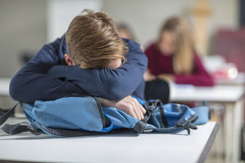 Teenage boy sleeping in class - ZEF15672