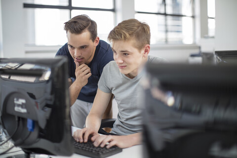 Lehrer und Schüler verwenden Computer im Unterricht, lizenzfreies Stockfoto