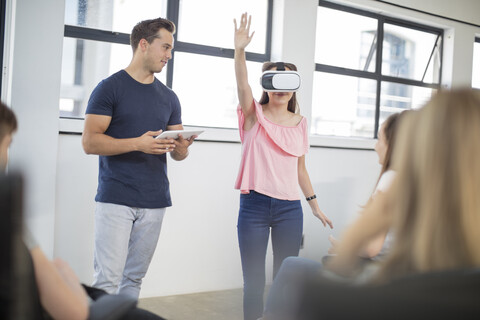 Teacher with tablet student wearing VR glasses in class stock photo