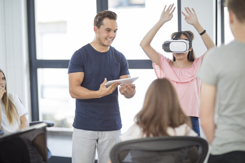 Teacher with tablet student wearing VR glasses in class stock photo