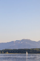 Germany, Bavaria, Chiemsee, sailing boat in the evening light - MMAF00380