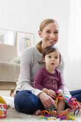 Mother and baby boy, at home, playing together - CUF24544