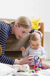 Mother and baby girl, at home, playing together - CUF24547