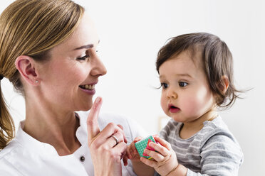 Paediatrician doing assessment of baby boy - CUF24569