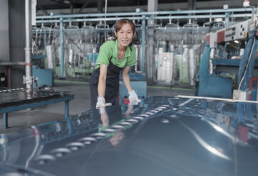 Worker in solar panel assembly factory, Solar Valley, Dezhou, China - CUF24680