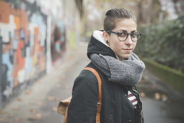 Teenager auf der Straße, Graffiti-Wand im Hintergrund - CUF24825