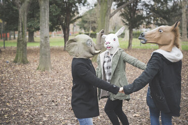 Drei Schwestern mit Tiermasken tanzen im Park - CUF24855