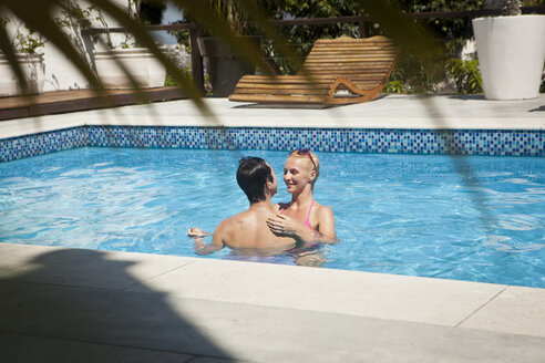 Heterosexual couple in swimming pool together, face to face - CUF25385