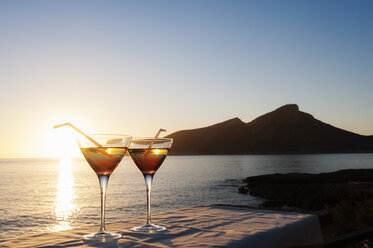 Sunset over sea with two cocktails on table, Mallorca, Spain - CUF25591