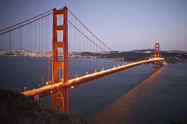 View of traffic light trails crossing Golden Gate Bridge at dusk, San Francisco, California, USA - ISF09488