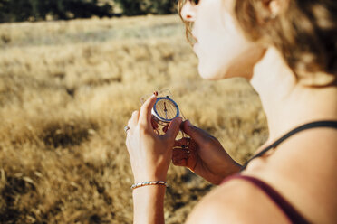 Over shoulder view of woman using compass - ISF09500