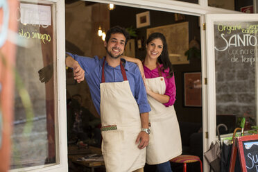 Restaurant owners standing at entrance of cafe, Palma de Mallorca, Spain - CUF25901