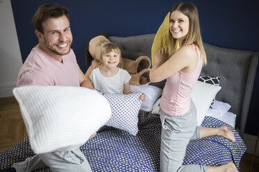 Happy family having fun in bedroom, having a pillow fight - AWF00019
