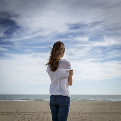 Rear view of mid adult woman looking out to sea, Castelldefels, Catalonia, Spain - CUF26061