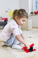 Girl sweeping floor with brush at home - CUF26204