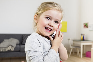 Girl talking on smartphone at home - CUF26223