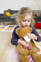 Girl playing mummy to bear - CUF26229