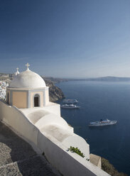 Blick auf die weiß getünchte Kirche und die Meeresfähren, Oia, Santorin, Kykladen, Griechenland - CUF26242