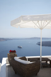 View of rooftop terrace and sea ferry, Oia, Santorini, Cyclades, Greece - CUF26249