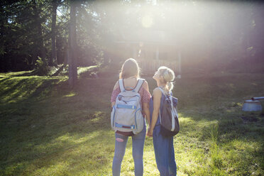 Rear view of two female friends in forest glade, Sattelbergalm, Tyrol, Austria - CUF26263