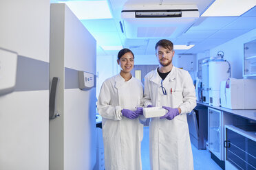 Scientists in laboratory looking at camera - CUF26387