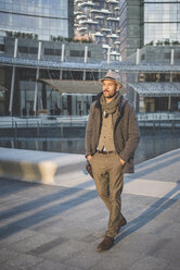 Businessman walking outside office building - CUF26657