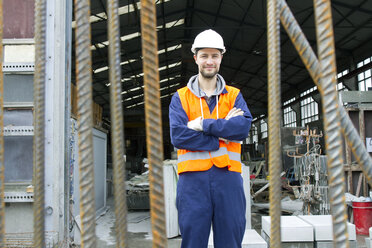 Portrait of factory worker outside concrete reinforcement factory - CUF26986