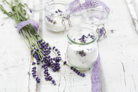 Glass of homemade lavender sugar with lavender blossoms stock photo