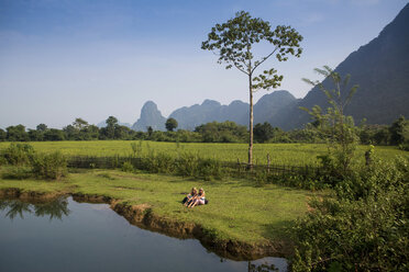 Zwei Freundinnen entspannen sich am Nam Song-Flussufer, Vang Vieng, Laos - CUF27176