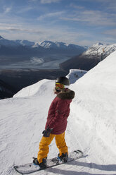 Young woman snowboarding, Girdwood, Anchorage, Alaska - CUF27178