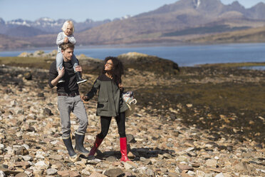 Family on walk, man carrying son on shoulders, Loch Eishort, Isle of Skye, Hebrides, Scotland - CUF27301