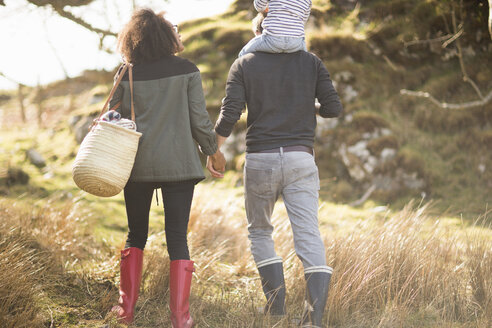 Mid adult couple on walk holding hands - CUF27337