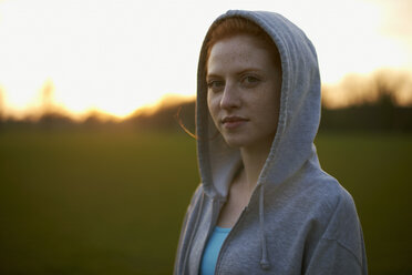 Portrait of woman with hood up after exercising in the park - CUF27367