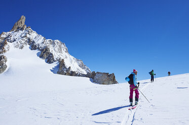 Three mature adult skiers moving up Mont Blanc massif, Graian Alps, France - CUF27412