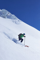 Mature male skier speeding down Mont Blanc massif, Graian Alps, France - CUF27425