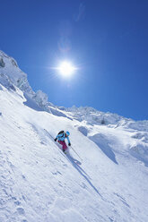 Mature female skier speeding downhill on Mont Blanc massif, Graian Alps, France - CUF27435