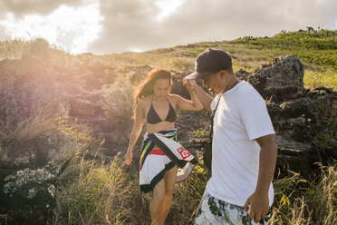Junger Mann hilft seiner Freundin auf dem Makapuu-Küstenpfad, Oahu, Hawaii, USA - CUF27455