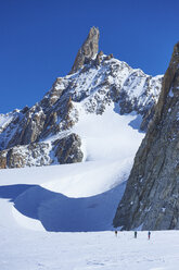 Distant view of three skiers on Mont Blanc massif, Graian Alps, France - CUF27494