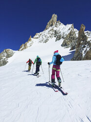 Rear view of three adult skiers moving up Mont Blanc massif, Graian Alps, France - CUF27497