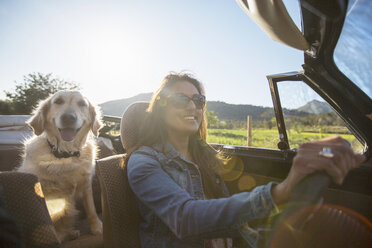 Mature woman and dog, in convertible car - CUF27546