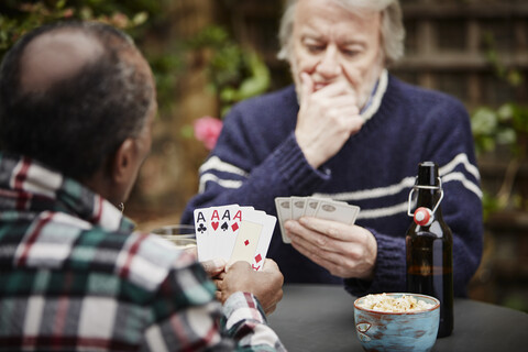 Two senior men playing cards stock photo