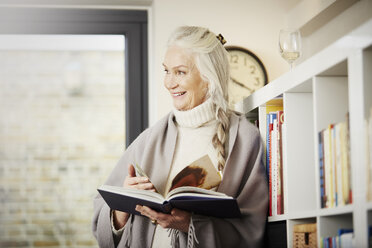 Senior woman reading book at home - CUF27655