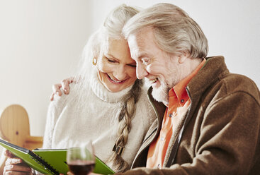 Senior couple looking at book - CUF27661