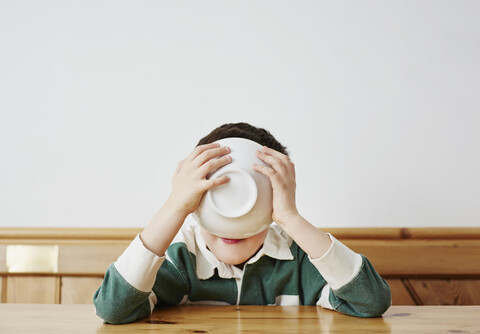 Boy drinking milk from bowl stock photo