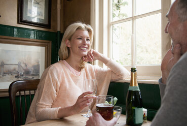 Couple drinking and talking in pub - CUF27707